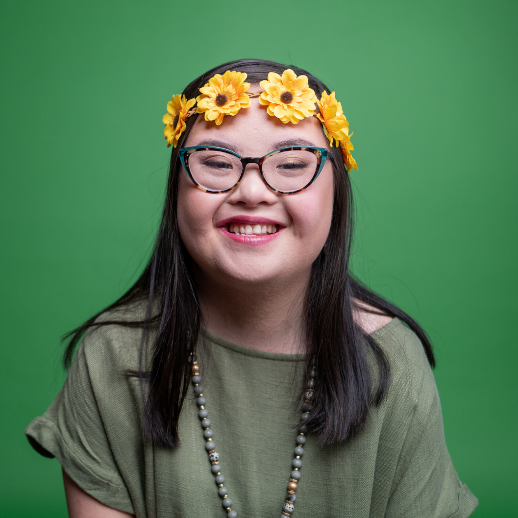 Youth Leader Group participant, Tiana, wearing yellow flower head band and smiling